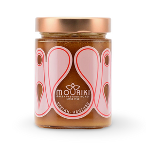 A jar of Mouriki - Greek Heather Honey with a pink label and branding since 1987.